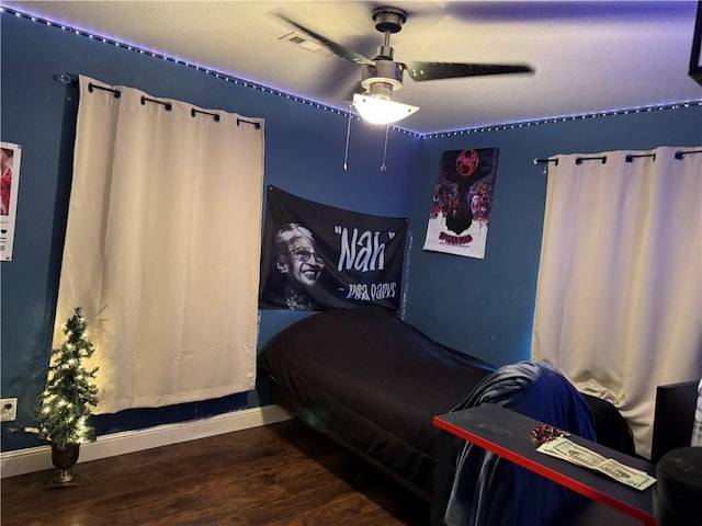 bedroom with ceiling fan and wood-type flooring