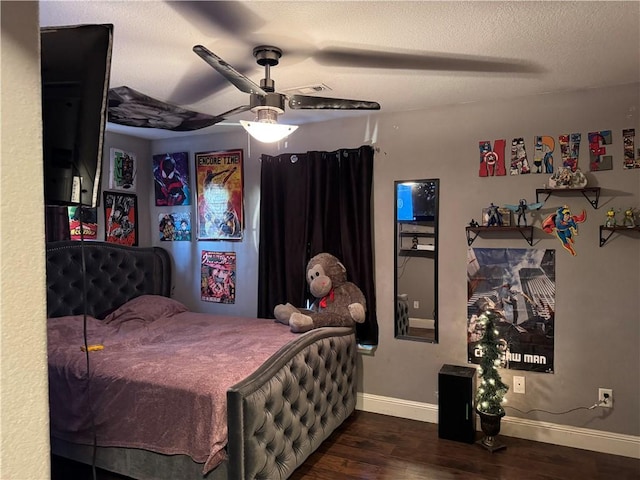 bedroom featuring a textured ceiling, dark hardwood / wood-style flooring, and ceiling fan