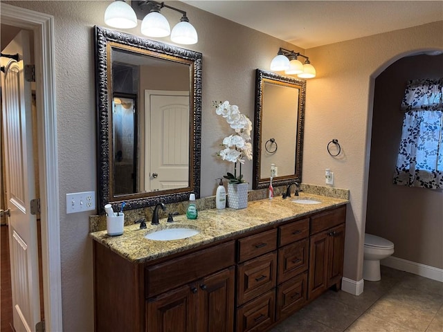 bathroom featuring tile patterned floors, vanity, and toilet