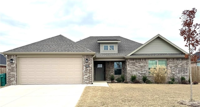 view of front of house with a garage and a front lawn