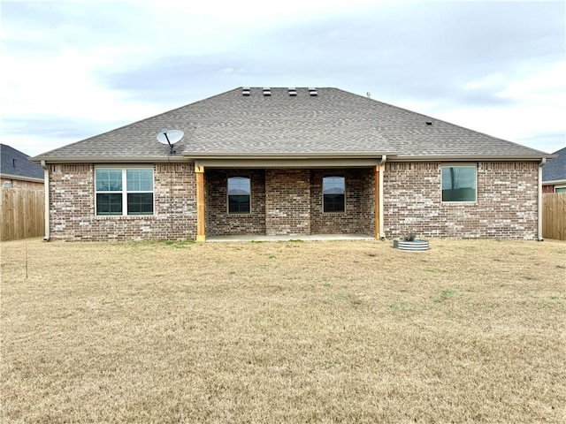 back of house with a lawn