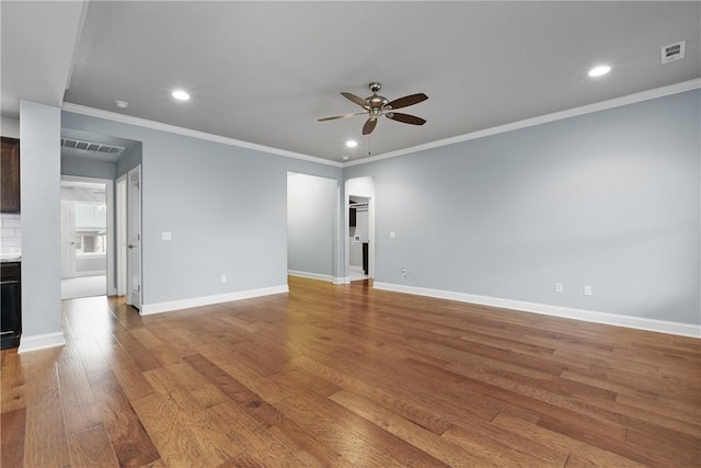 empty room featuring ornamental molding, ceiling fan, and light hardwood / wood-style flooring