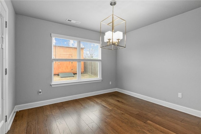 unfurnished dining area featuring a notable chandelier and hardwood / wood-style flooring