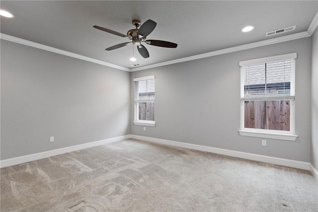 unfurnished room featuring ceiling fan, light colored carpet, and ornamental molding