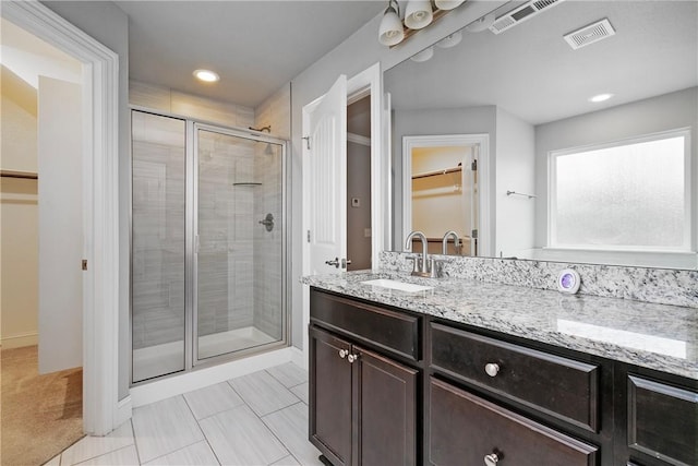 bathroom with vanity and walk in shower