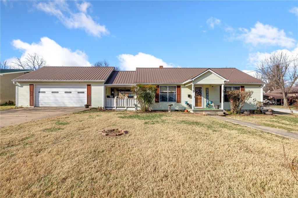 single story home featuring a front lawn, a porch, and a garage