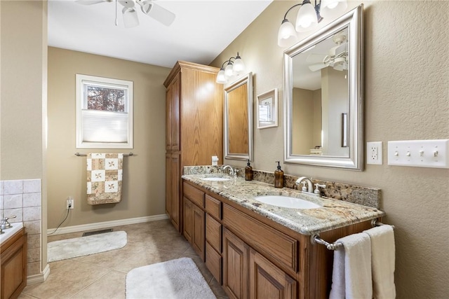 bathroom with ceiling fan, vanity, a washtub, and tile patterned floors