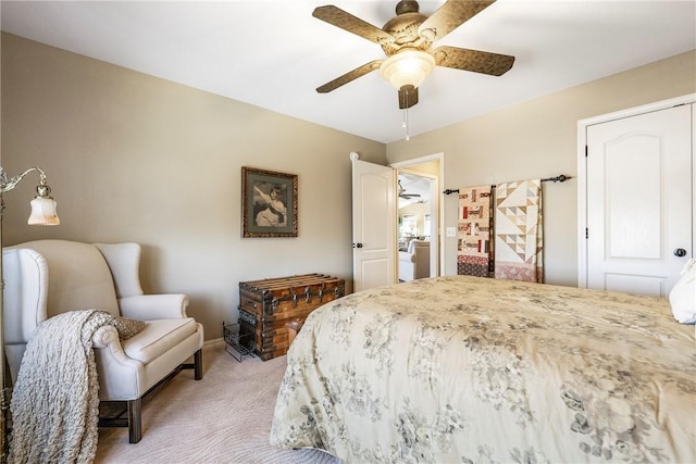 bedroom featuring light colored carpet, ceiling fan, and a closet