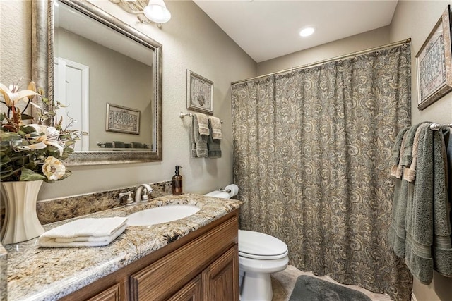 bathroom featuring toilet and vanity