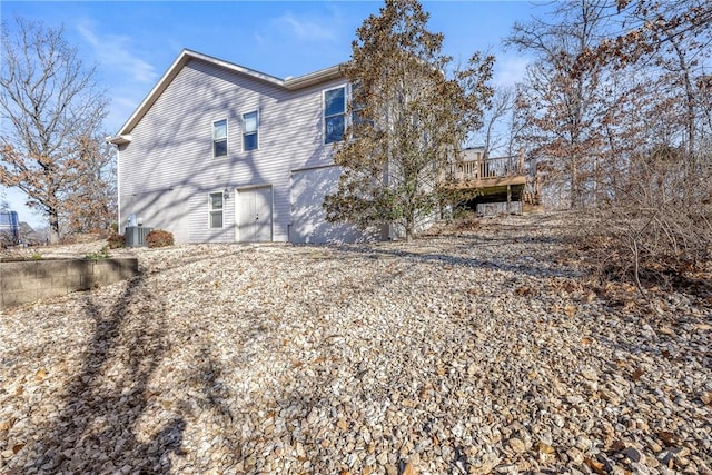 rear view of property with a deck and central AC unit