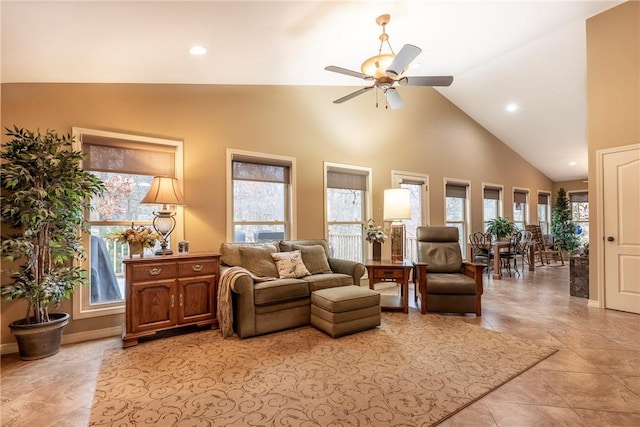 living room featuring ceiling fan, light tile patterned floors, and plenty of natural light