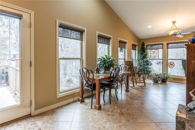 dining space featuring light tile patterned floors, ceiling fan, and vaulted ceiling