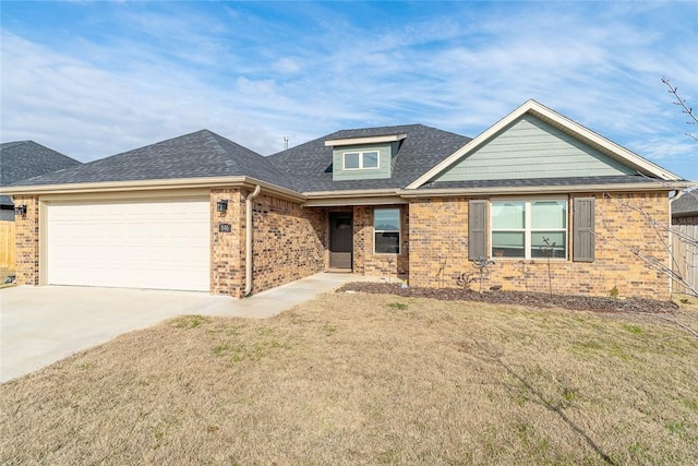 view of front of property with a front yard and a garage