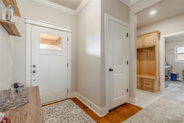 entrance foyer with light hardwood / wood-style flooring and ornamental molding