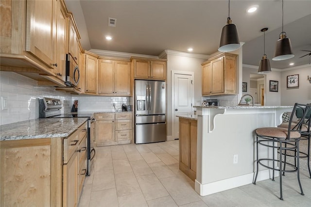 kitchen with a kitchen bar, appliances with stainless steel finishes, tasteful backsplash, light stone counters, and hanging light fixtures