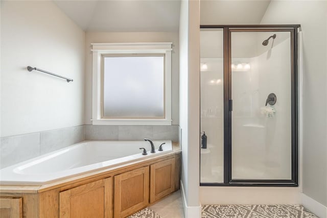 bathroom featuring tile patterned floors, separate shower and tub, and vaulted ceiling