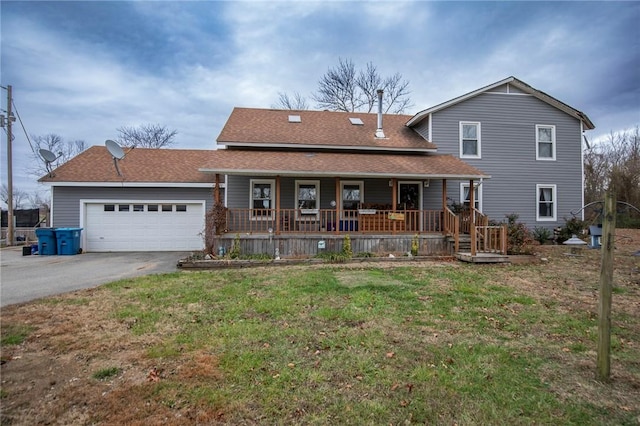 view of front of property with covered porch, a front yard, and a garage