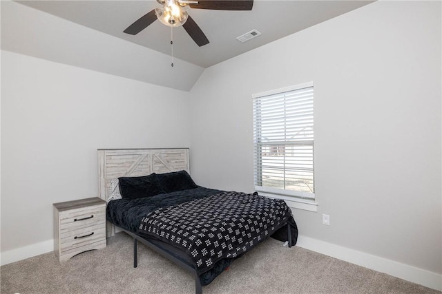 carpeted bedroom featuring multiple windows, vaulted ceiling, and ceiling fan