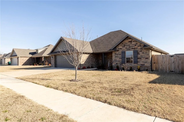 ranch-style house featuring a front lawn and a garage