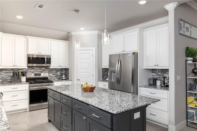 kitchen with backsplash, stainless steel appliances, a center island, white cabinetry, and hanging light fixtures