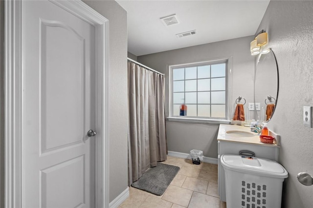 bathroom with tile patterned floors and vanity