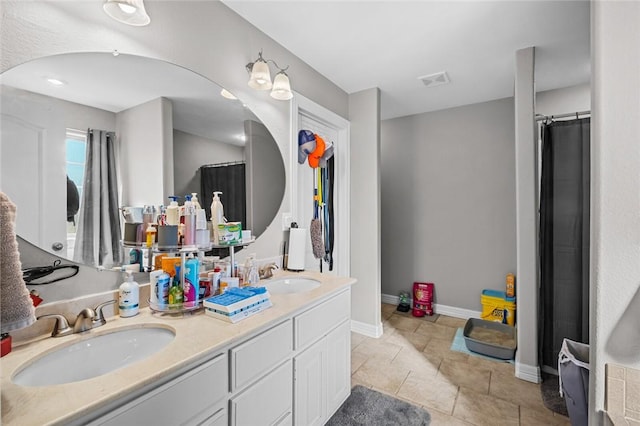 bathroom with tile patterned floors and vanity