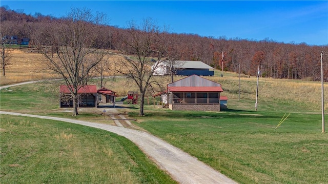 exterior space featuring a wooded view