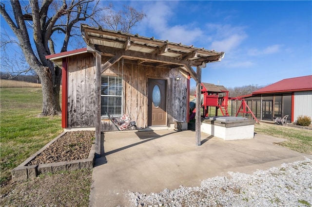 doorway to property featuring a yard and a patio