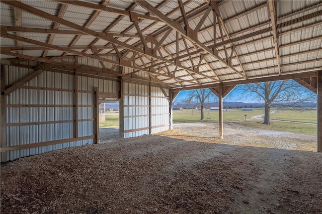 view of horse barn with a rural view