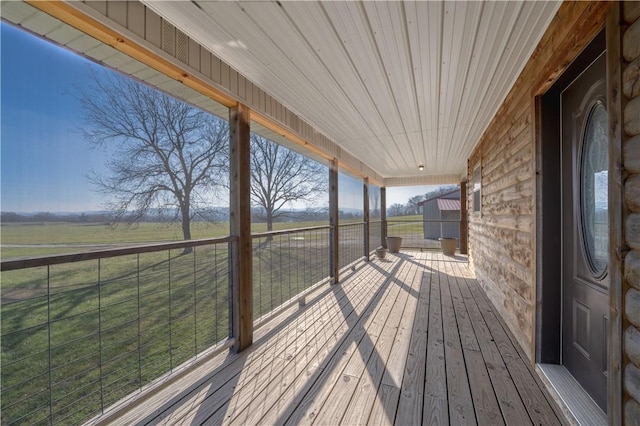 wooden deck with a rural view