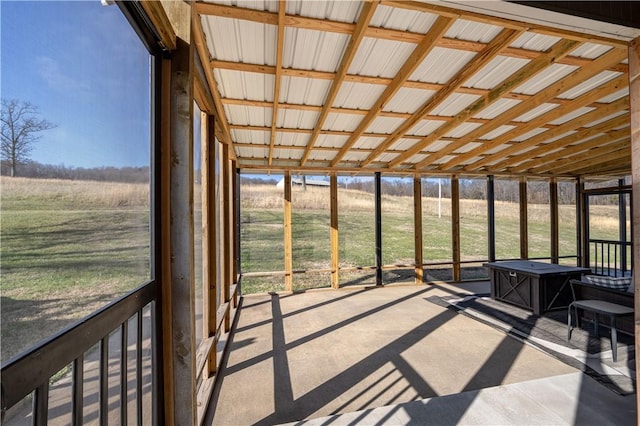 unfurnished sunroom featuring a rural view