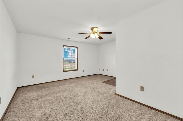 carpeted empty room featuring ceiling fan