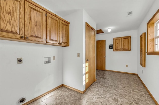 clothes washing area with washer hookup, hookup for an electric dryer, and cabinets