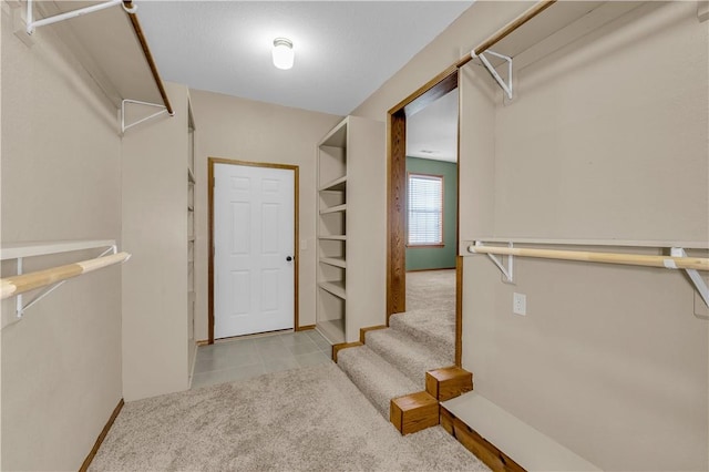 spacious closet with light colored carpet