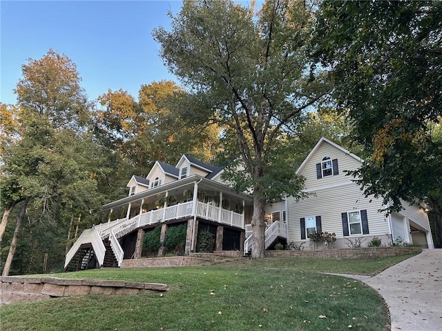 rear view of house with a yard and covered porch