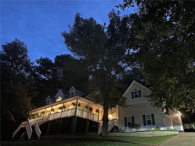 back house at dusk with a lawn