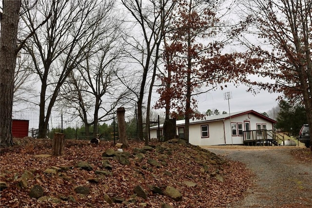 view of home's exterior featuring a wooden deck