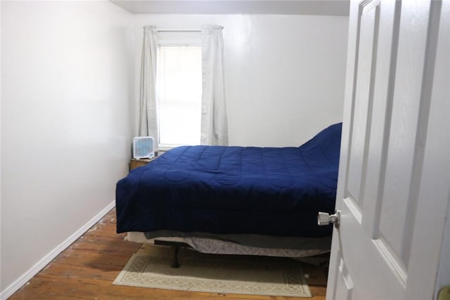 bedroom with dark hardwood / wood-style floors