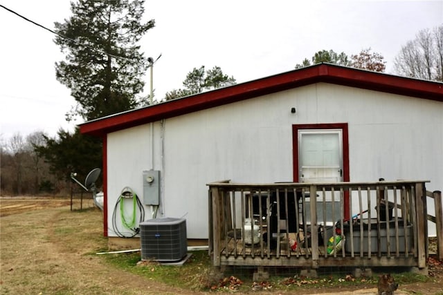 back of house with cooling unit and a deck