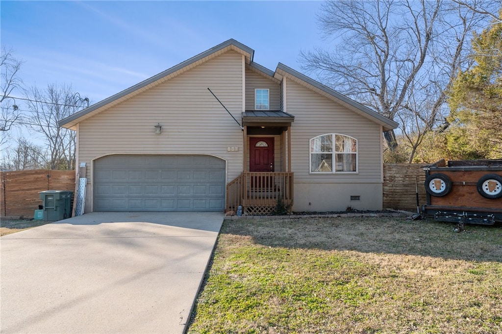 view of front of house featuring a garage and a front lawn