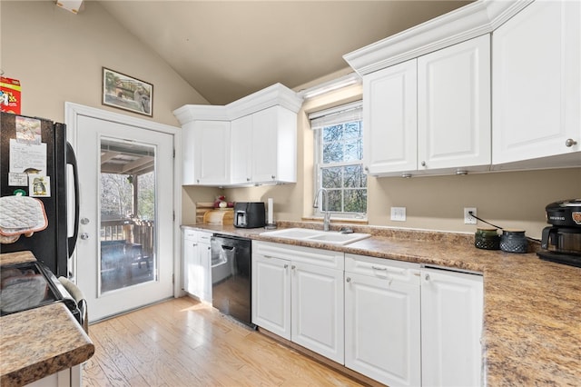 kitchen with white cabinetry, sink, light hardwood / wood-style floors, lofted ceiling, and black appliances