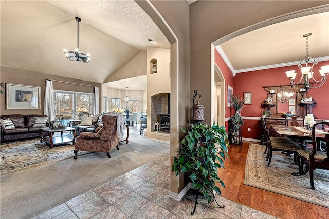 interior space featuring arched walkways, an inviting chandelier, a textured ceiling, crown molding, and carpet floors