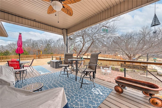 view of patio / terrace featuring outdoor dining area, a wooden deck, a ceiling fan, and fence