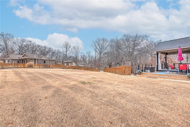 view of yard with a deck and fence