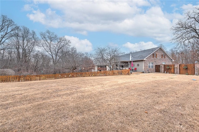 view of yard featuring fence and a deck