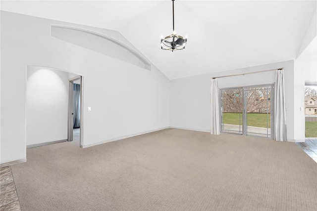 unfurnished living room with carpet floors, high vaulted ceiling, baseboards, and a notable chandelier