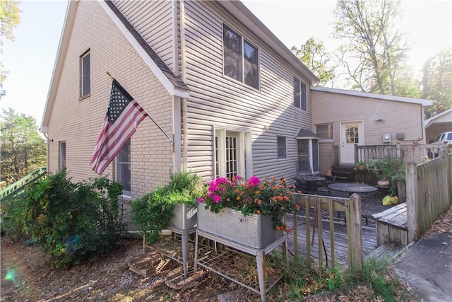 rear view of house featuring a deck