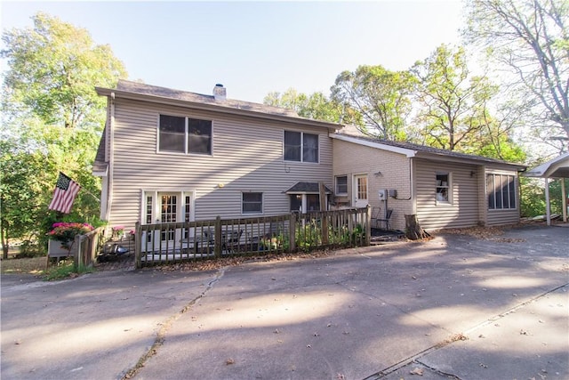 back of house with a wooden deck