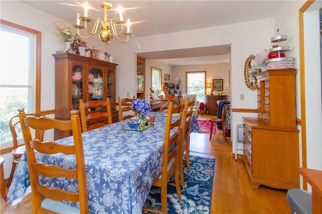 dining room with a chandelier and light hardwood / wood-style flooring