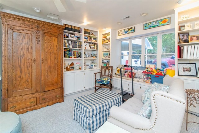 sitting room featuring built in features and light carpet